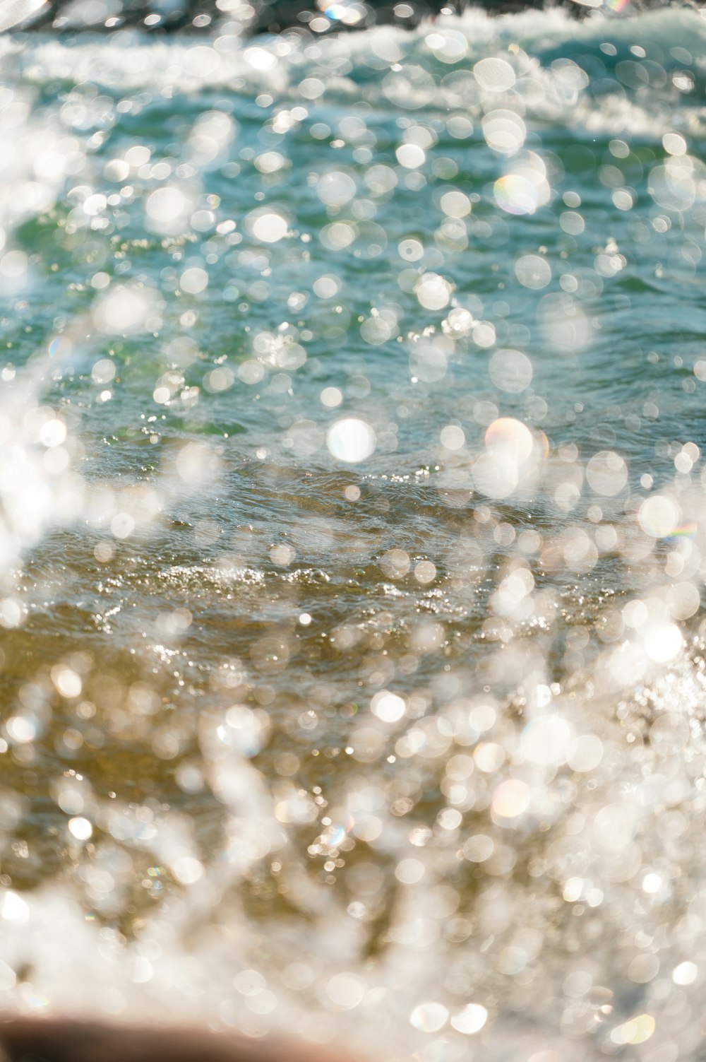 water splash on body of water during daytime