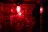 A dimly lit room with eerie red and black shadows casting mysterious shapes on the walls.