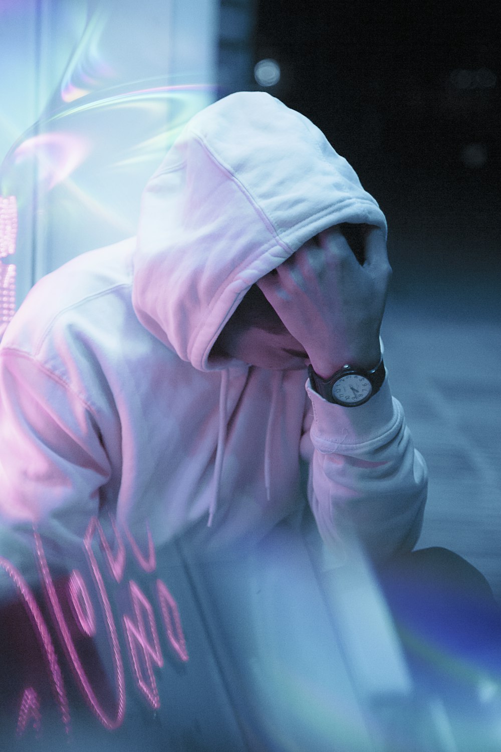 man in white hoodie wearing black round analog watch