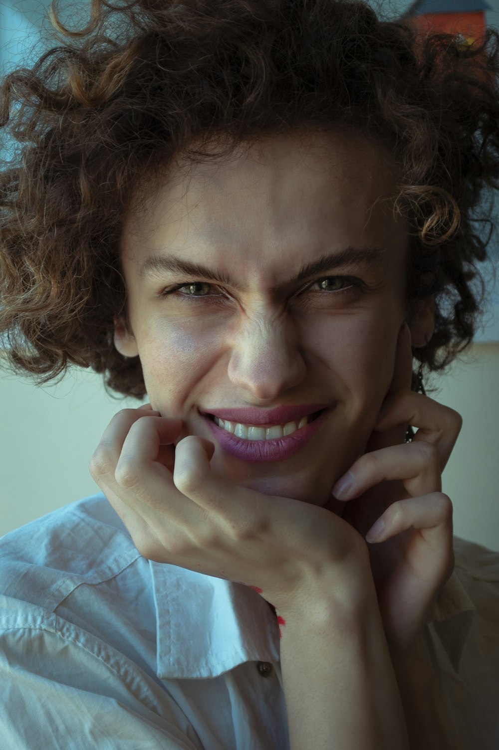 woman in blue dress shirt smiling