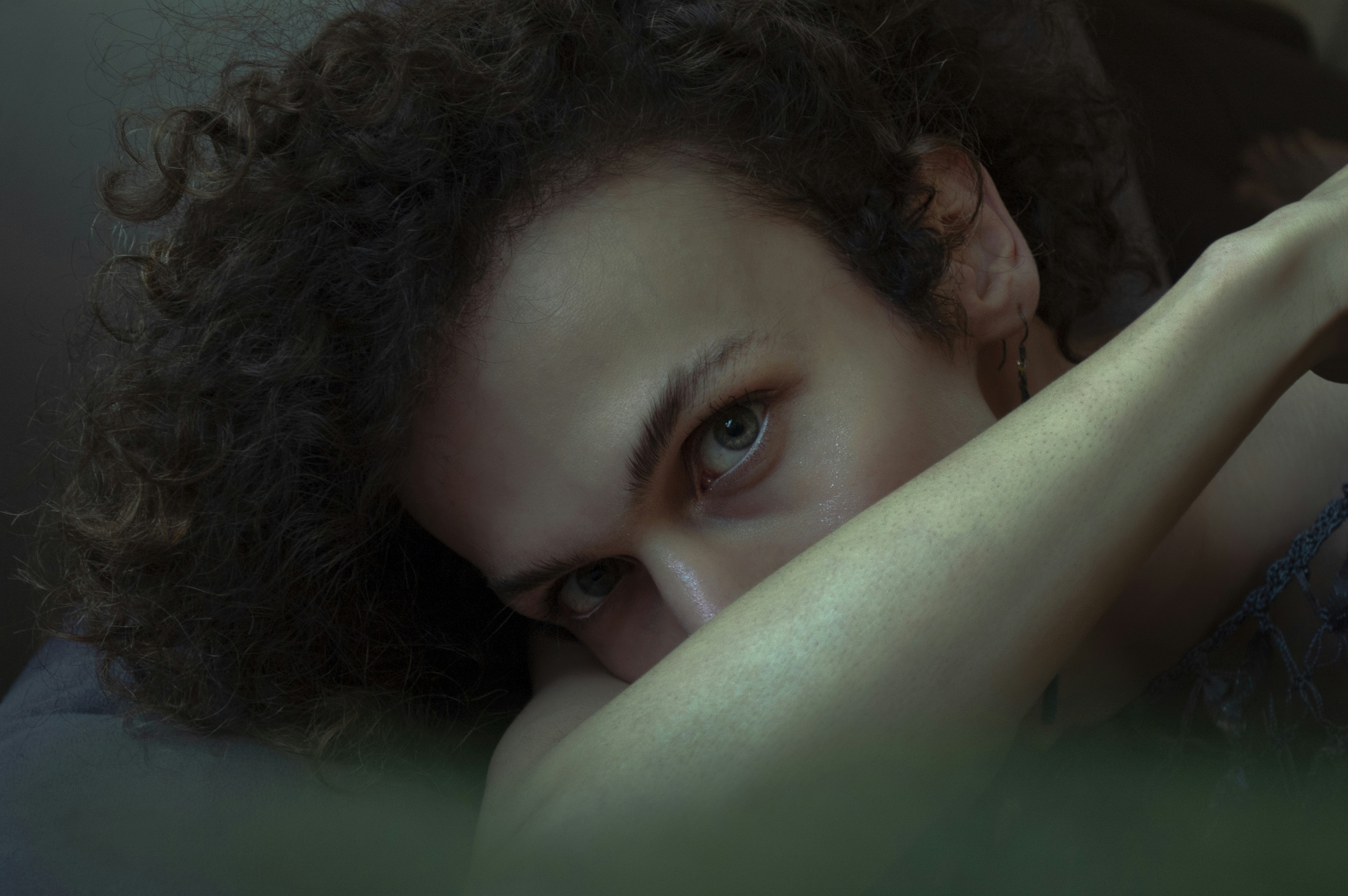 woman lying on green textile