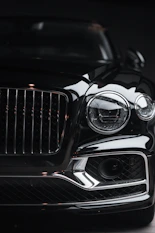 silver car headlight in grayscale photography