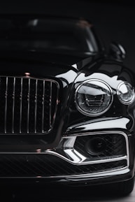silver car headlight in grayscale photography