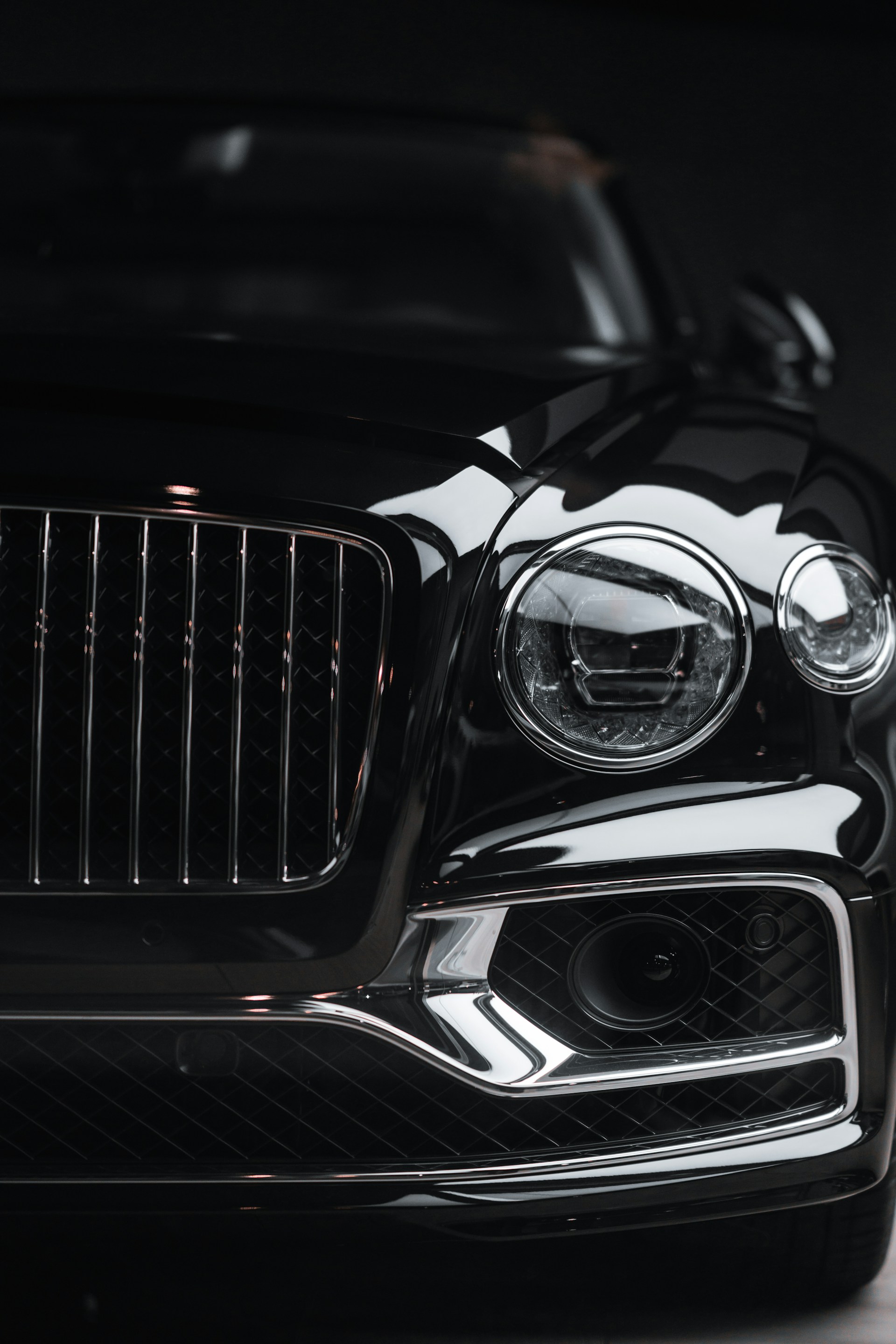 silver car headlight in grayscale photography