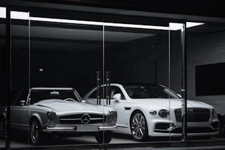 white mercedes benz coupe parked in front of black building