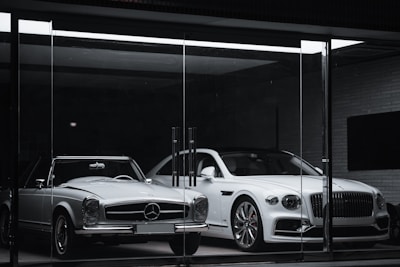 white mercedes benz coupe parked in front of black building