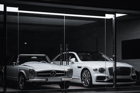 white mercedes benz coupe parked in front of black building