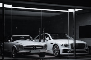 white mercedes benz coupe parked in front of black building