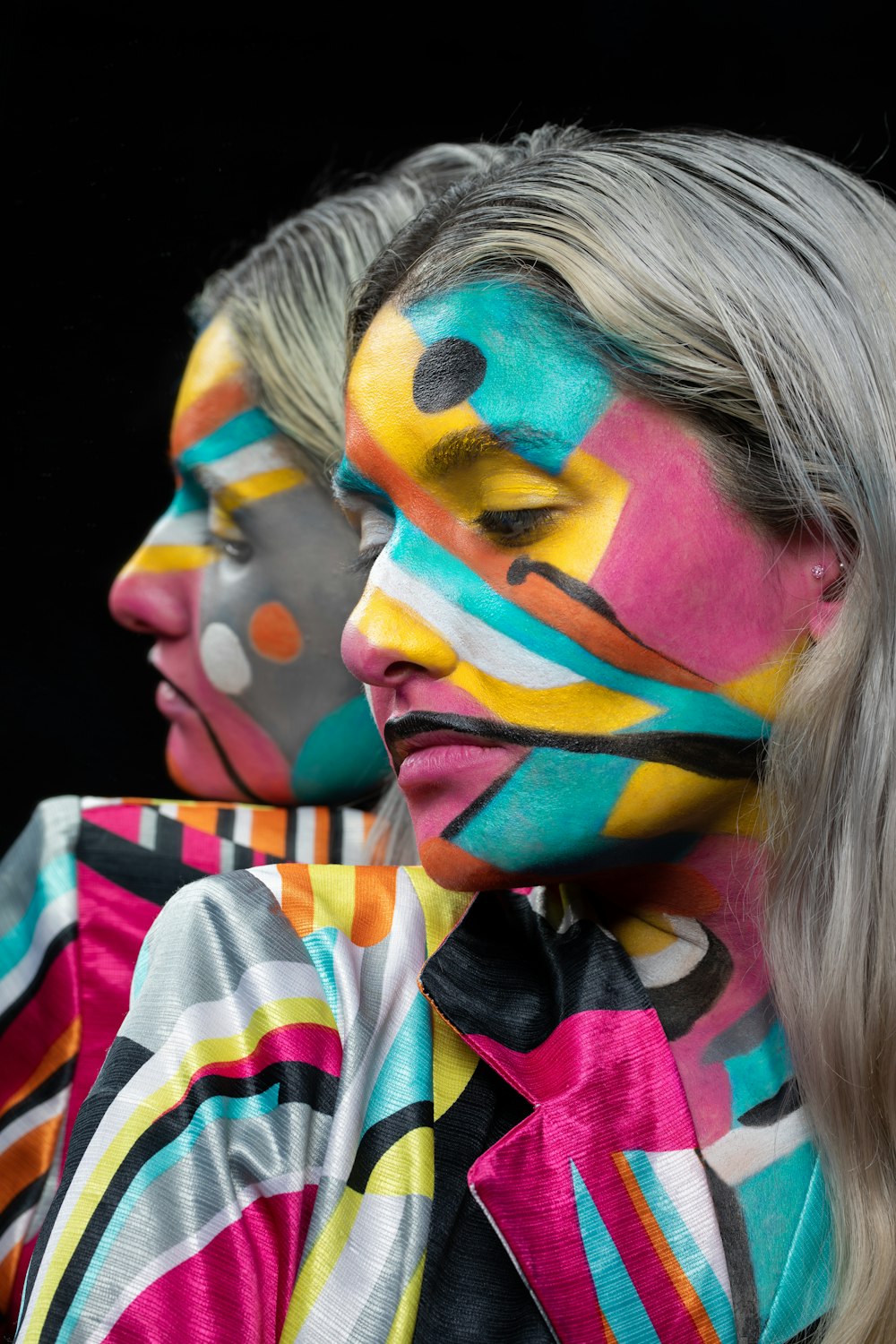 woman with blue pink and yellow face paint
