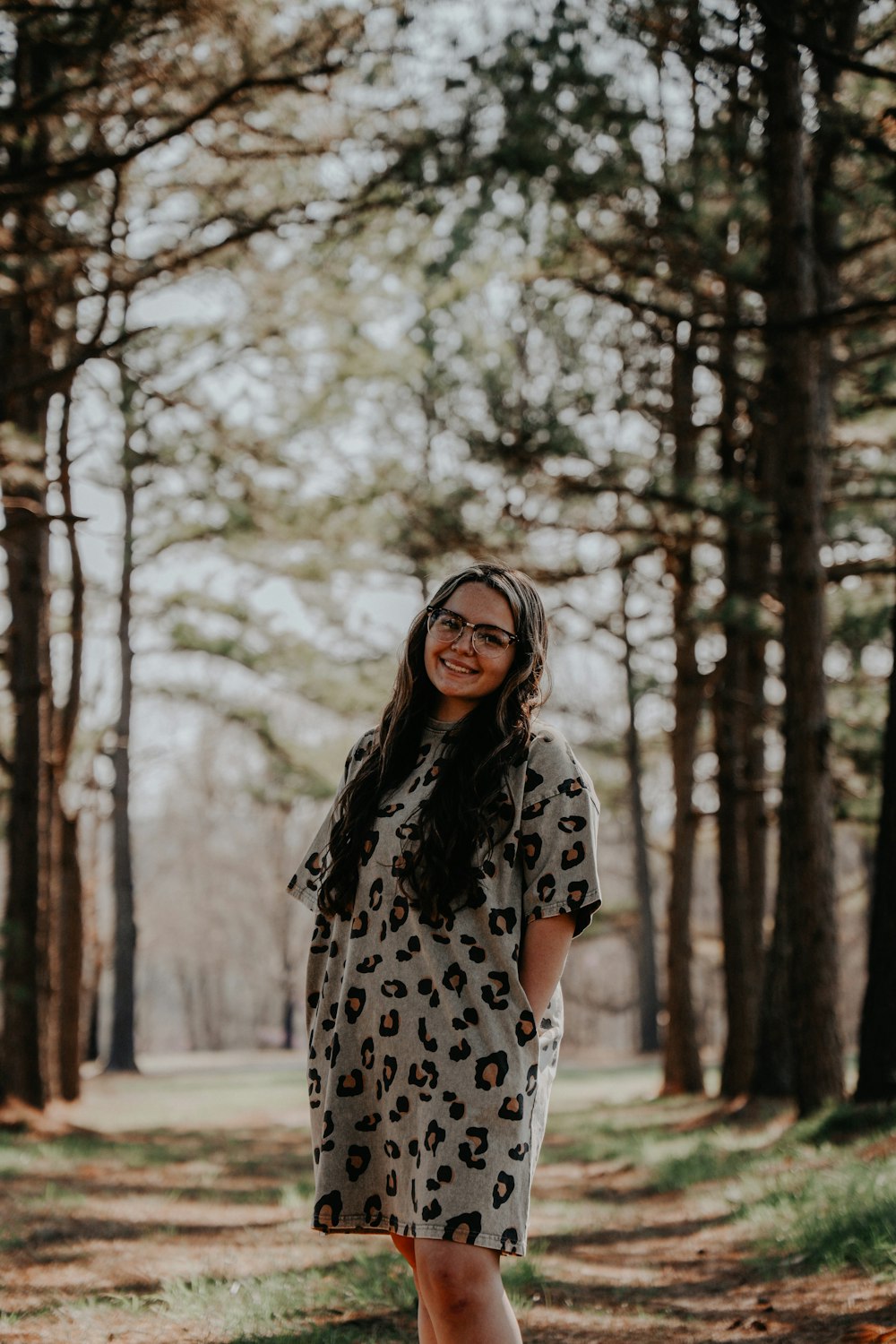 woman in black and white polka dot dress standing on snow covered ground during daytime