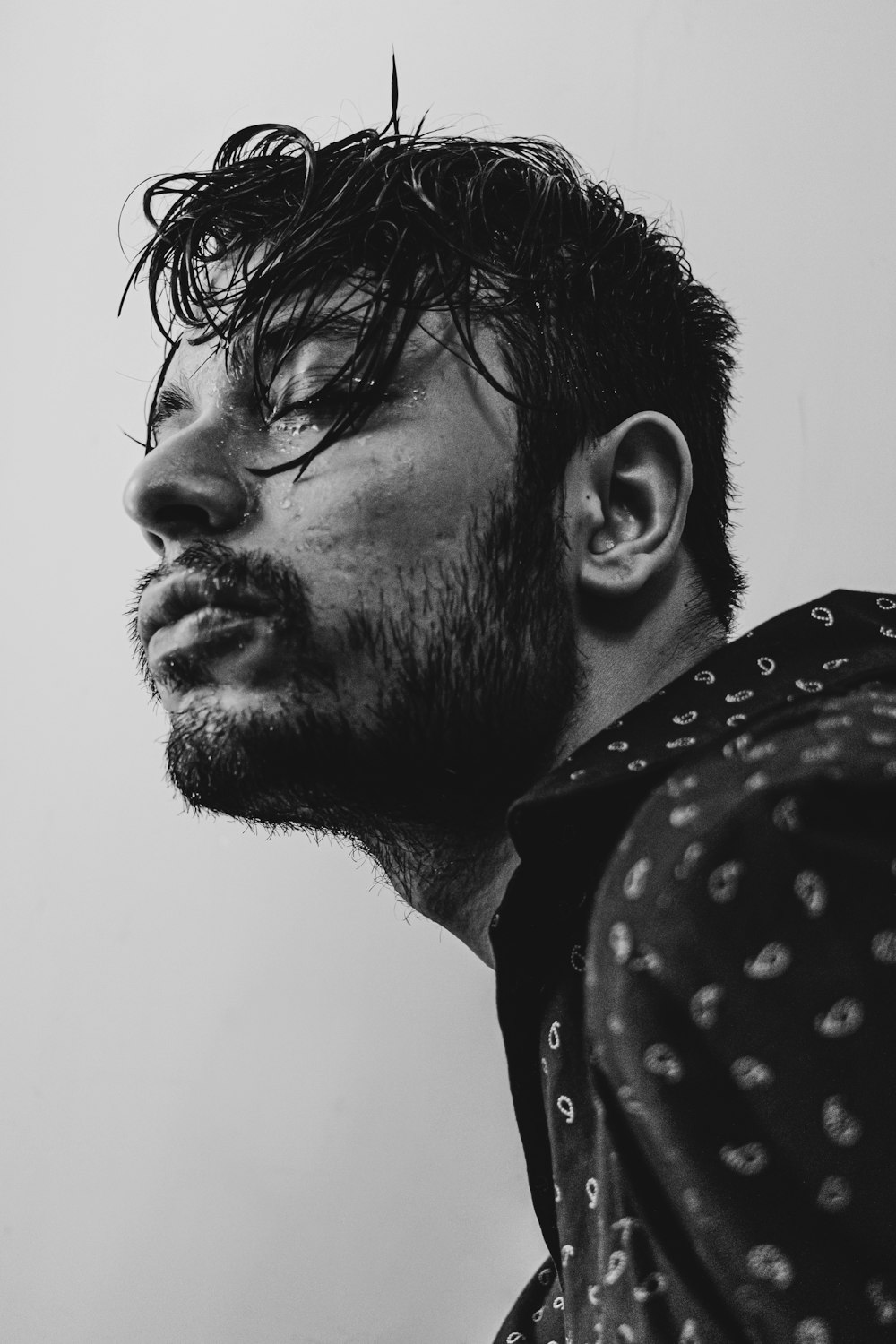 man in black and white polka dot shirt