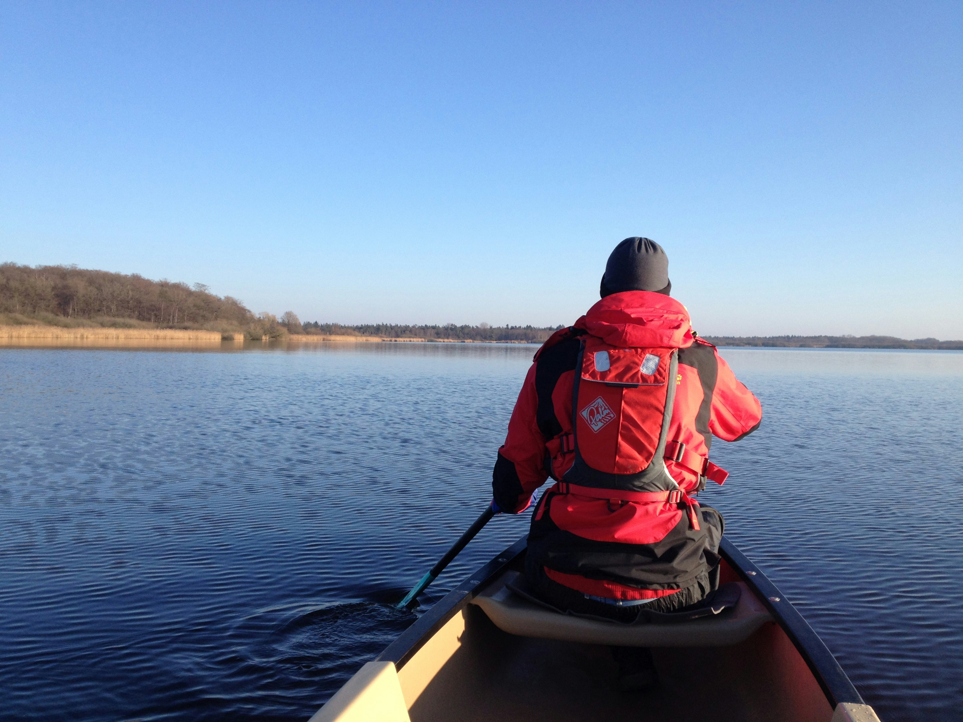 man in red and black jacket riding on yellow kayak during daytime