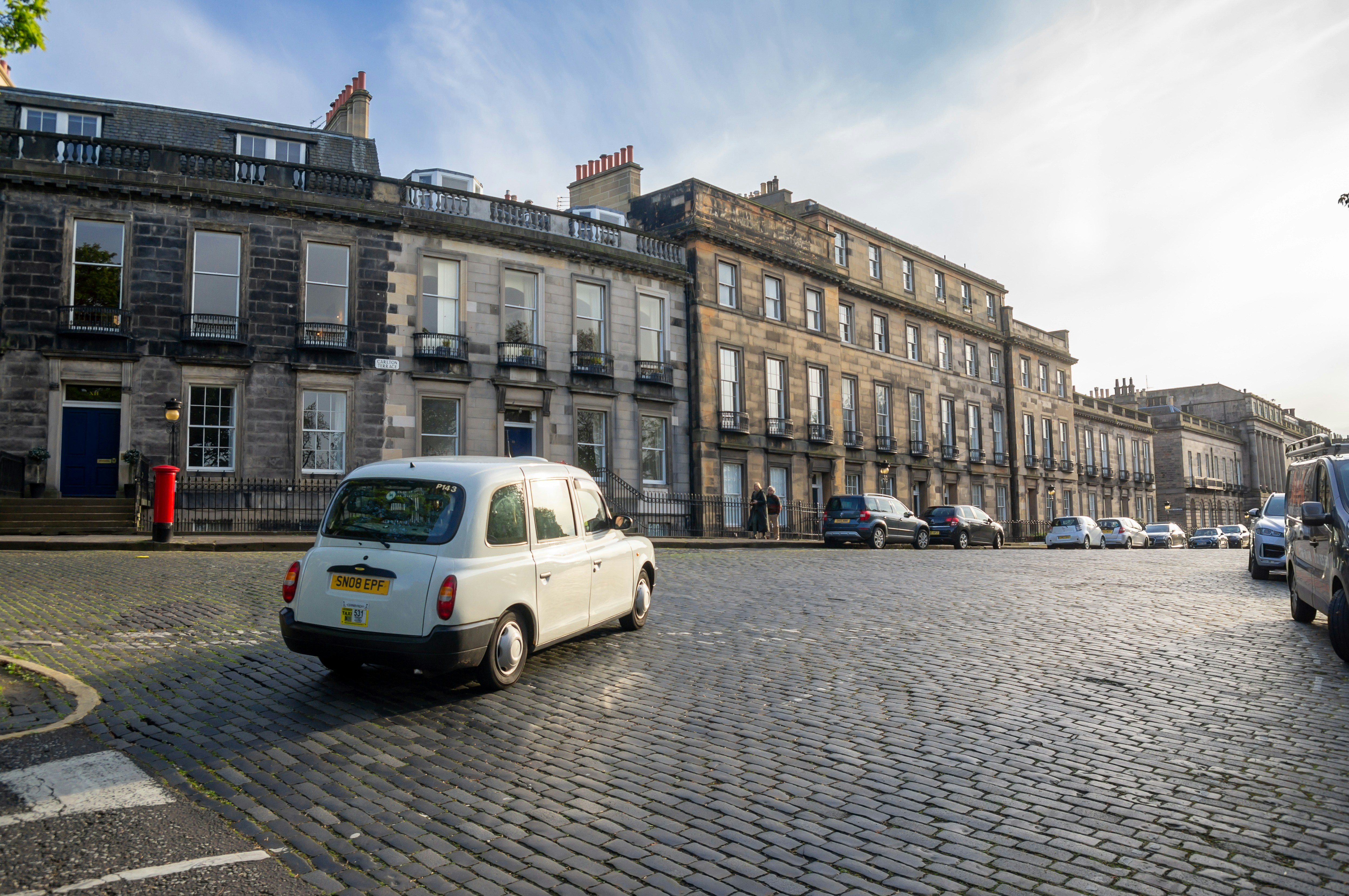 white van parked near building during daytime