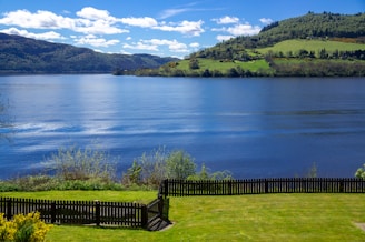 black wooden fence near lake during daytime