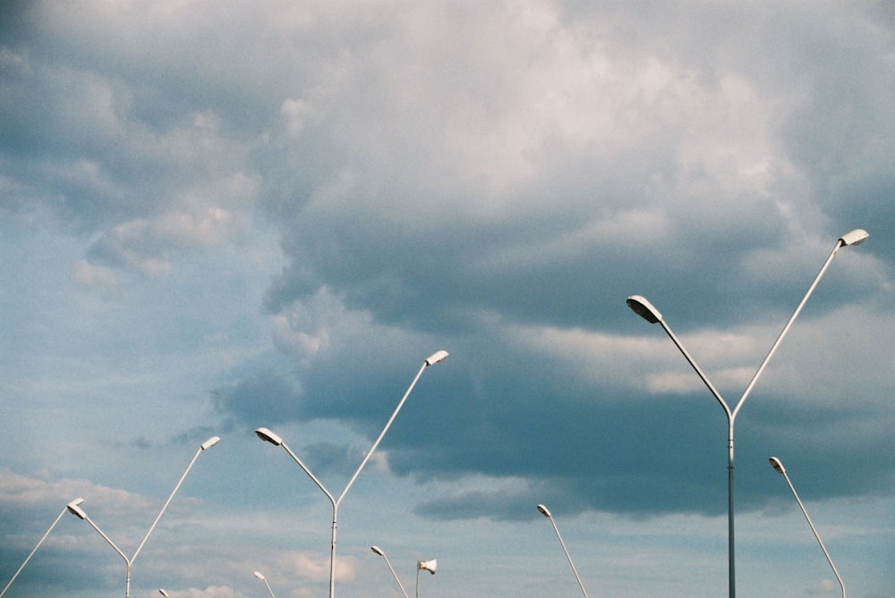 white wind turbines under white clouds and blue sky during daytime