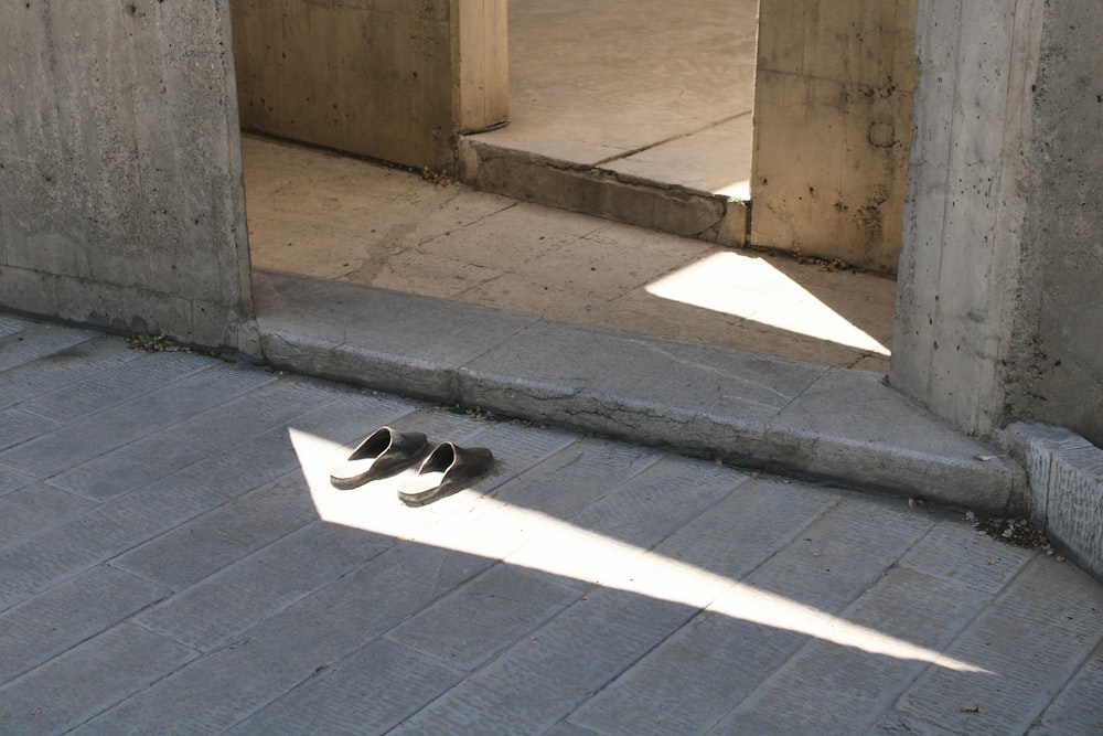 black flip flops on black floor