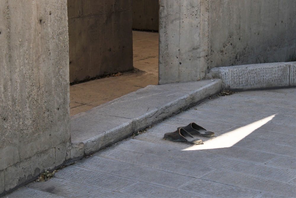 black and white nike sneakers on gray concrete floor