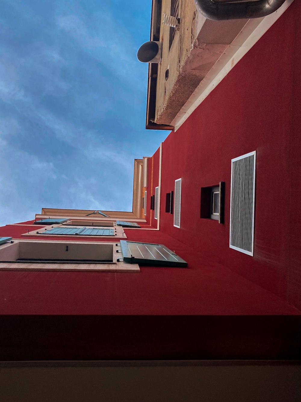 red and white concrete building under blue sky during daytime