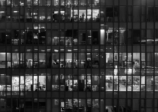 Office building with energy-efficient lighting visible through windows at dusk