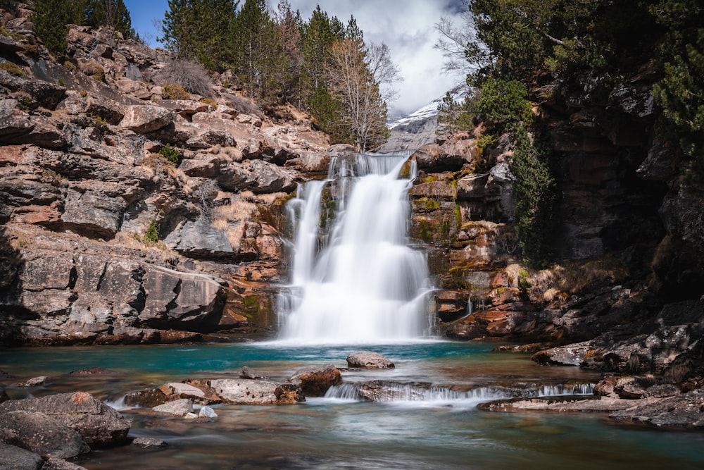 waterfalls on rocky mountain during daytime