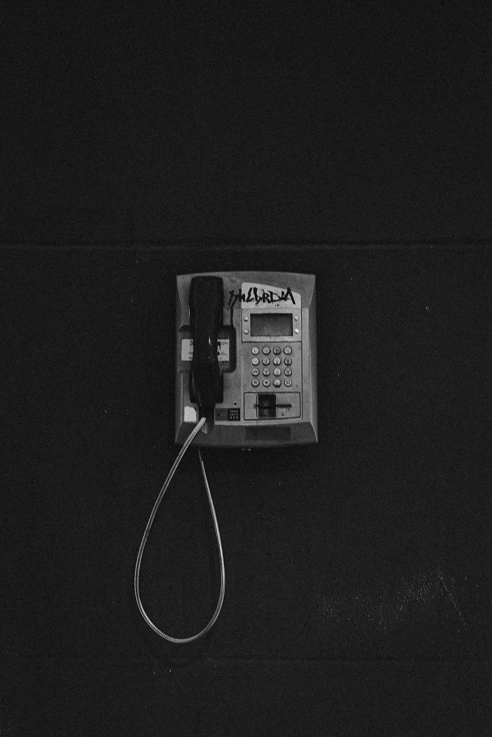 black and white telephone on black surface