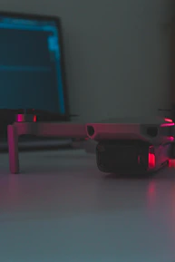 Close-up of a technician operating a drone with a lidar scanner in an industrial environment.