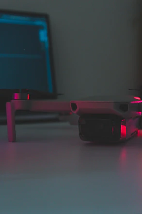 A skilled technician repairing a drone with precision tools in a bright workshop.