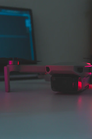 Close-up of a technician operating a drone with a lidar scanner in an industrial environment.