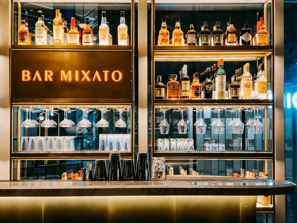 clear glass bottles on brown wooden shelf