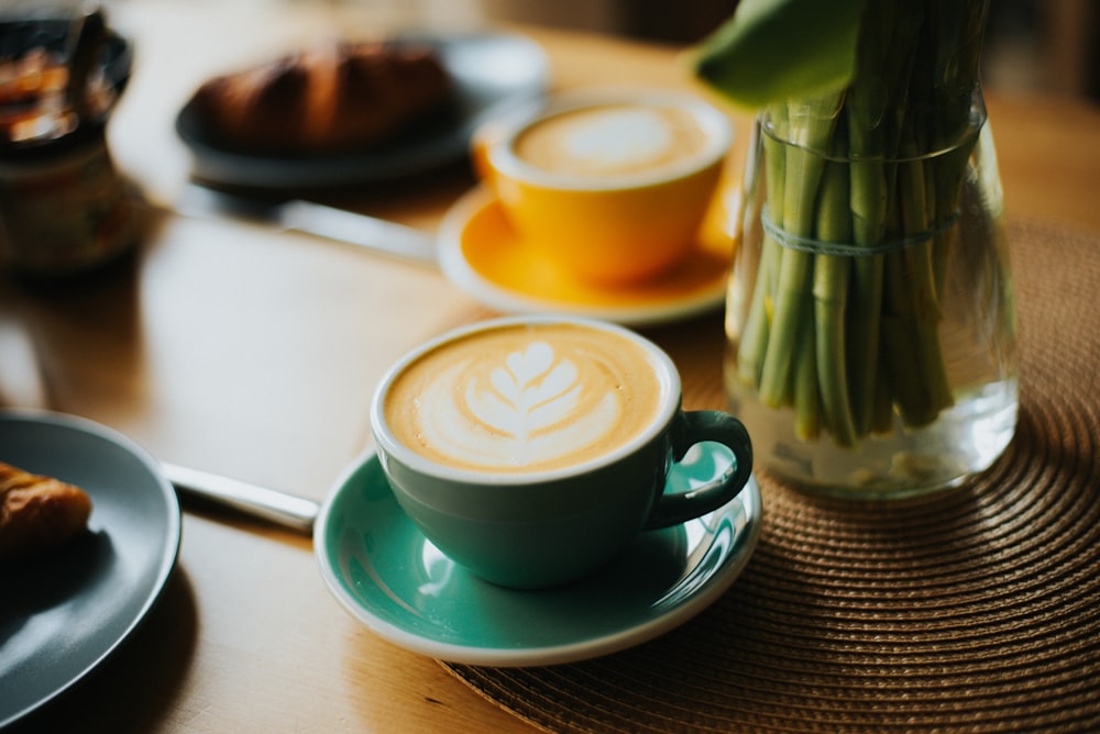 a cup of coffee sitting on top of a table