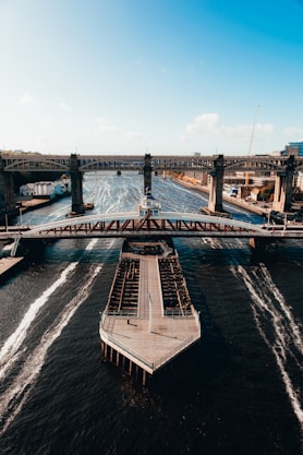 gray concrete bridge over body of water during daytime