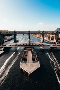gray concrete bridge over body of water during daytime