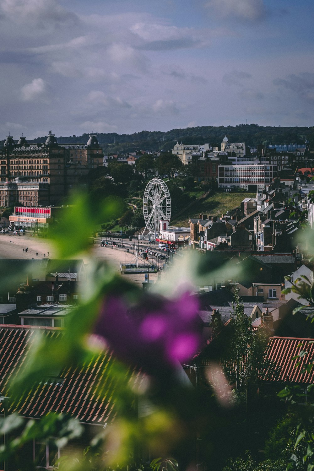 Weißes Riesenrad in der Nähe von braunem Betongebäude tagsüber