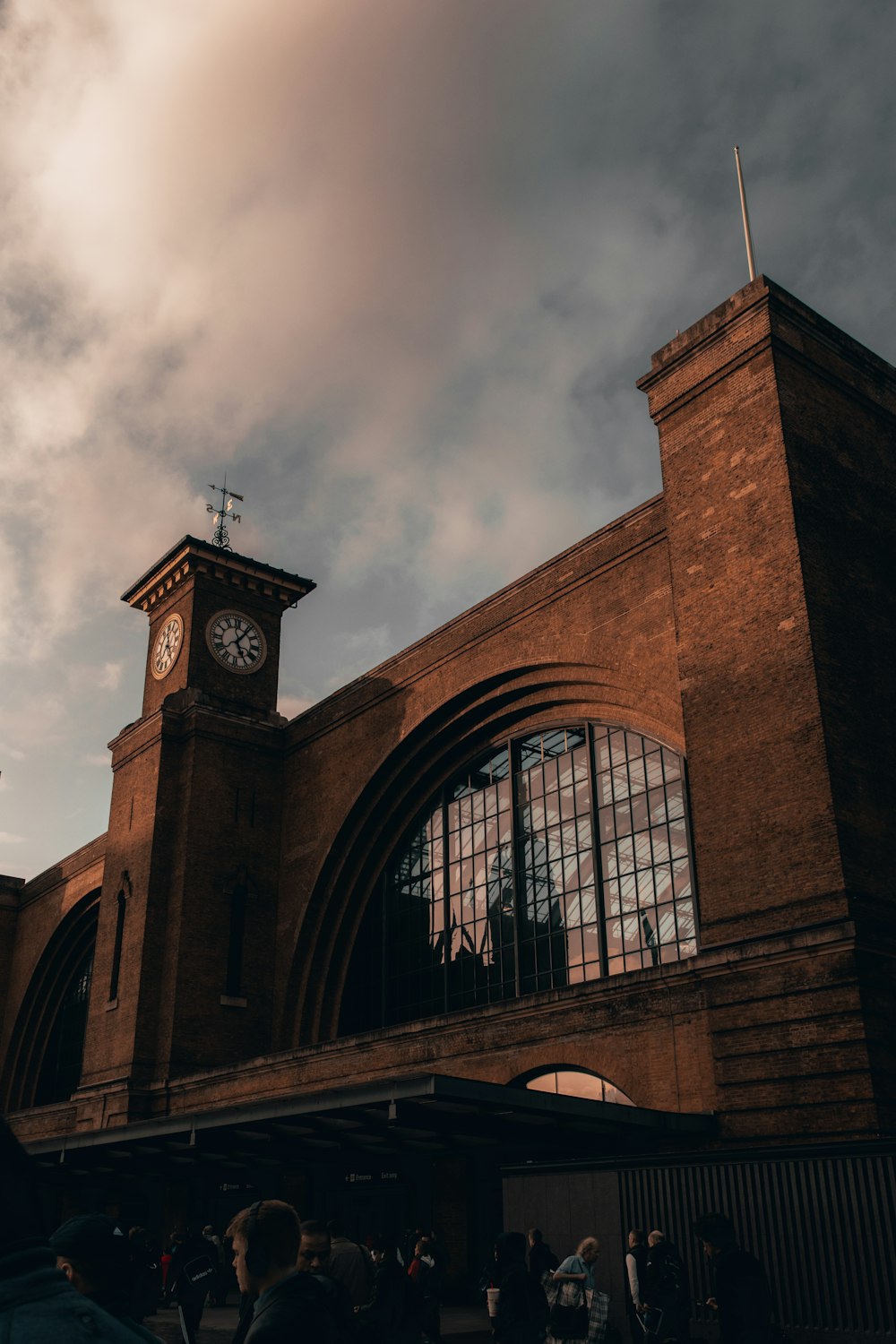 brown brick building under cloudy sky during daytime