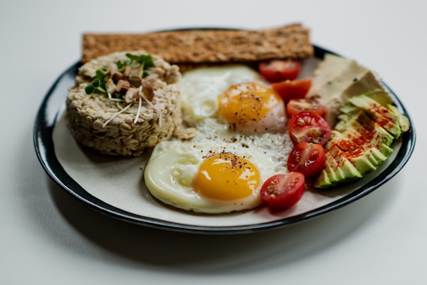 Sliced bread with egg and vegetable on white ceramic plate