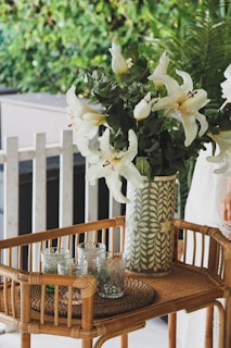 white flowers in white and blue ceramic vase on table