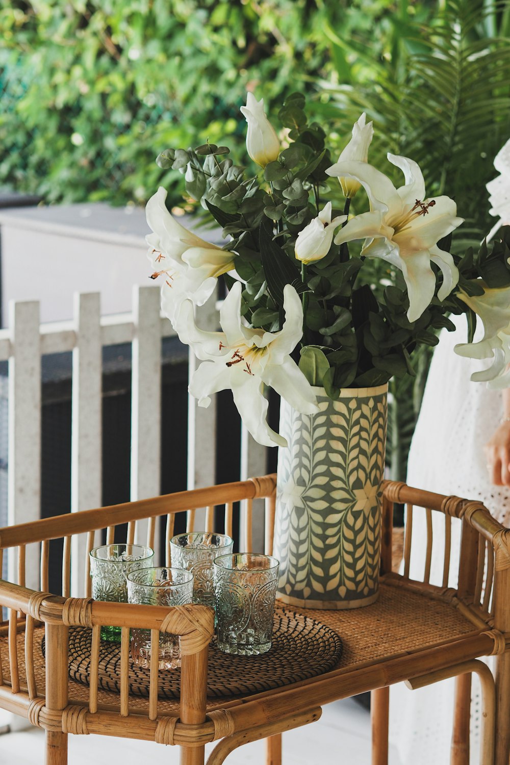 white flowers in white and blue ceramic vase on table