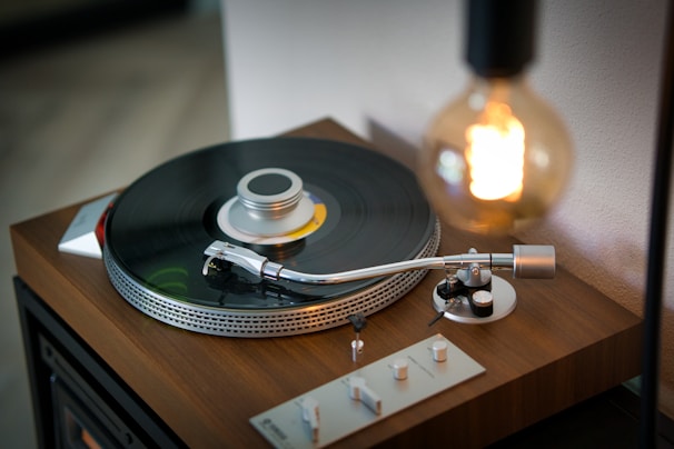 A vintage vinyl record player spinning a classic rock album under soft warm light.