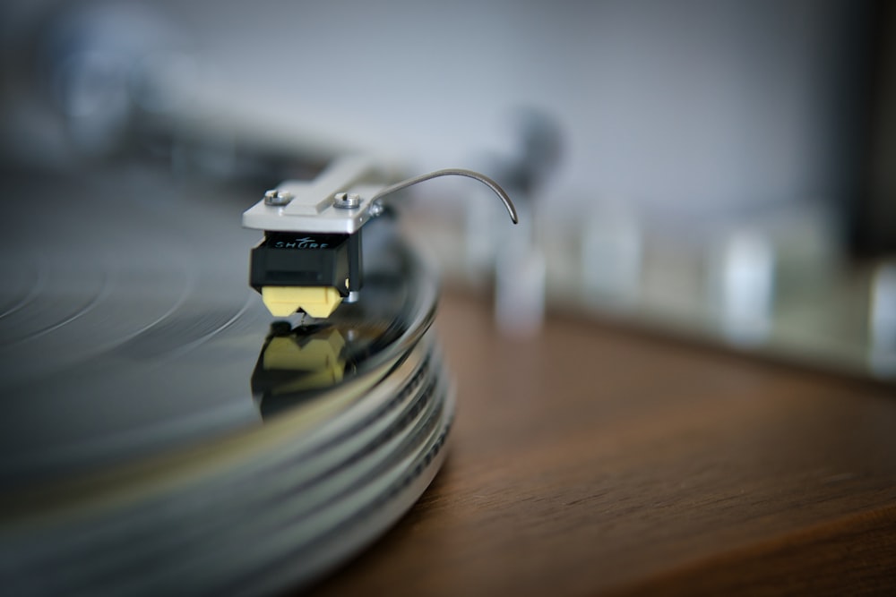 silver and gold electronic device on brown wooden table