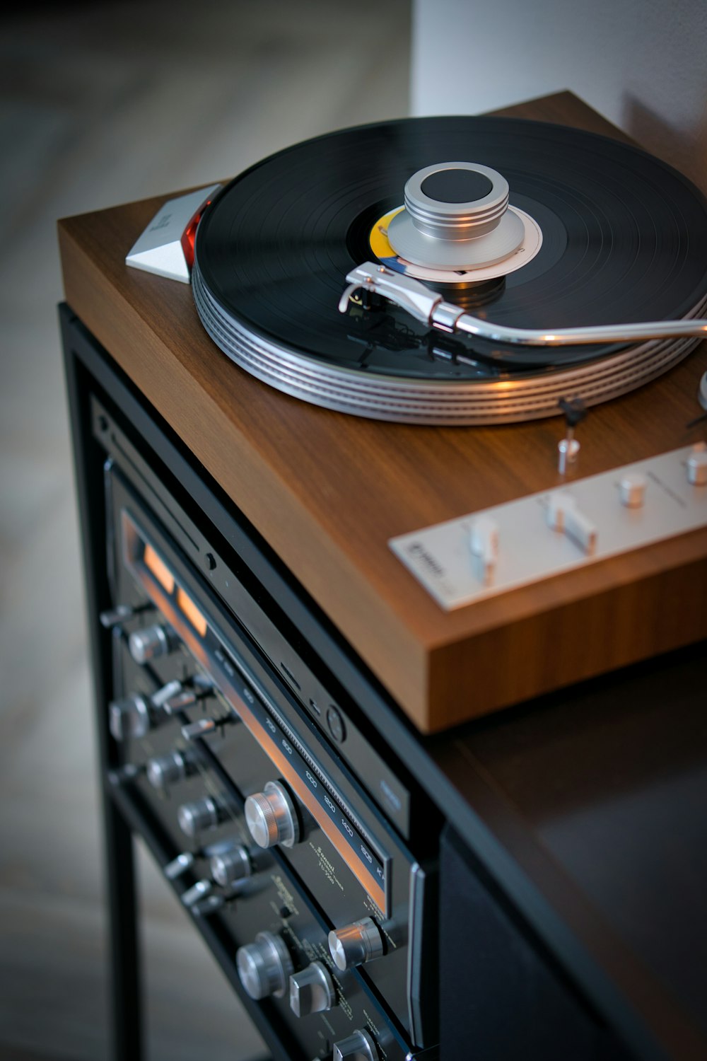 vinyl record player on brown wooden table