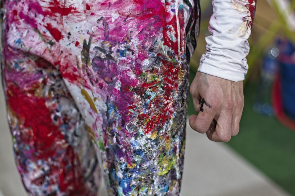 person in red white and green floral long sleeve shirt