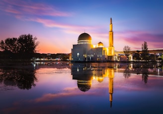 white dome building near body of water during sunset