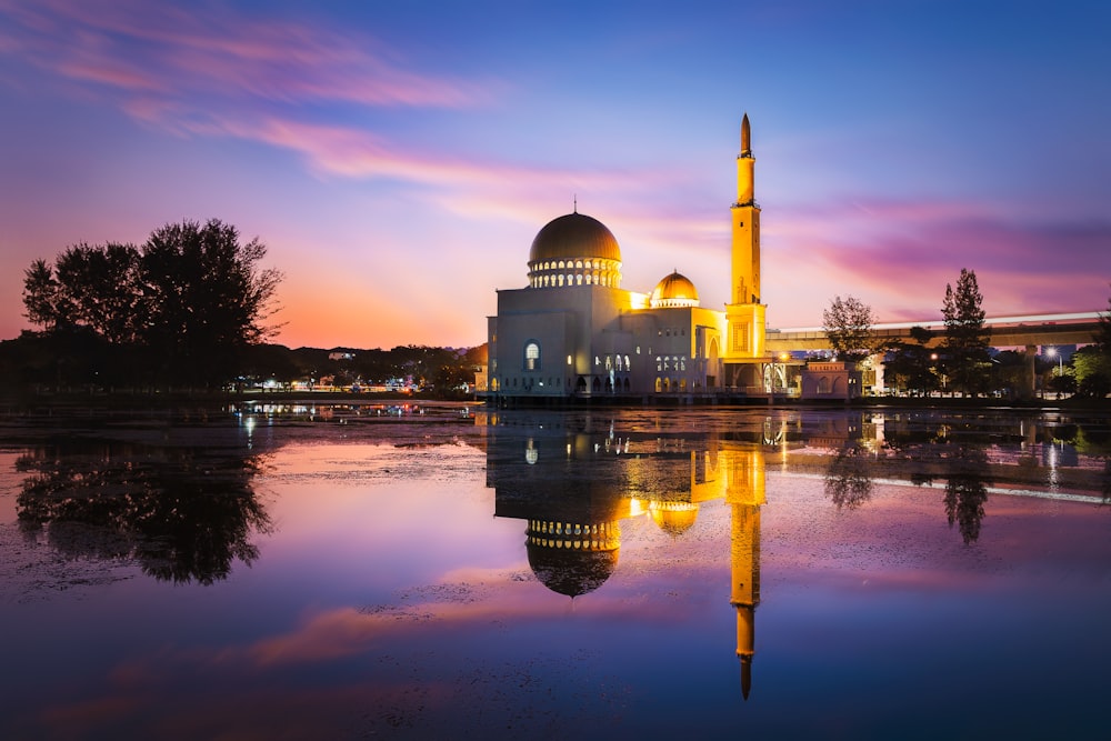 white dome building near body of water during sunset