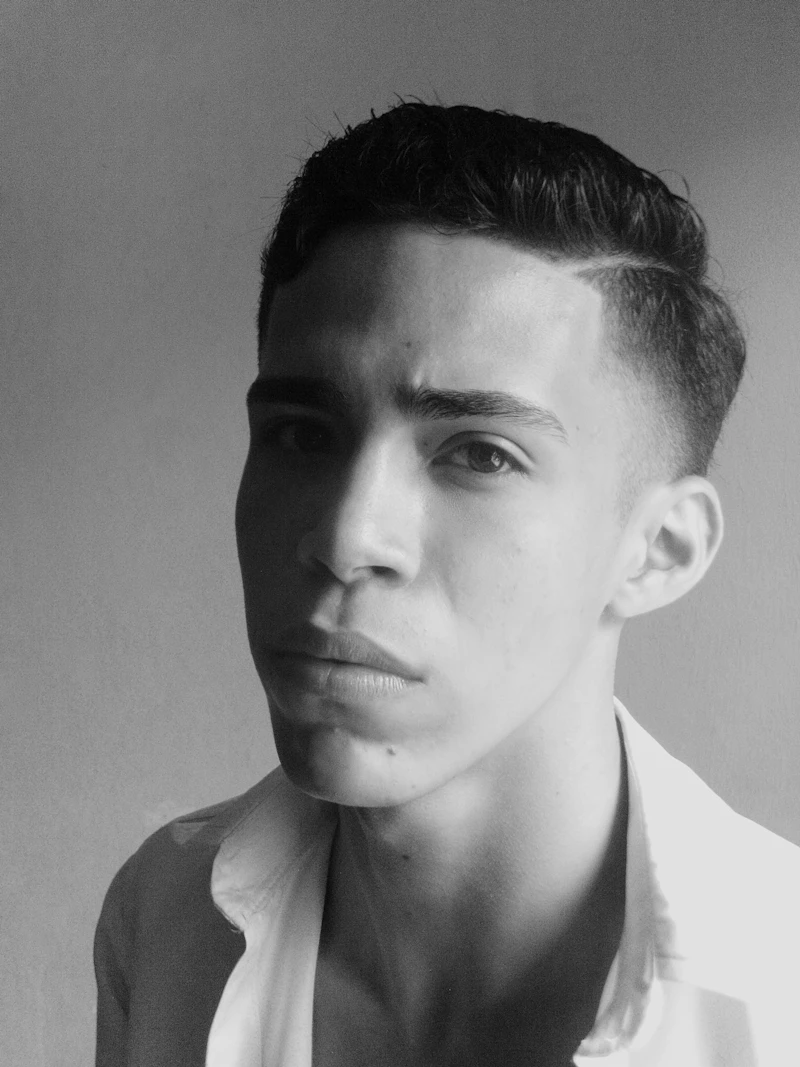 A young man with a tight skin fade and a short textured top