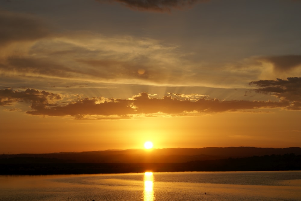 body of water during sunset