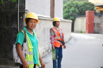 woman in green crew neck t-shirt wearing yellow hard hat
