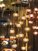 Close-up of traditional Arabic lanterns casting a cozy glow on the dining area aboard the cruise.