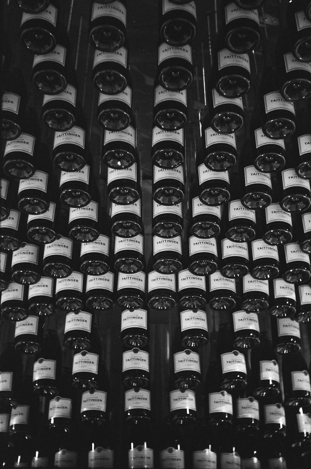 black glass bottles on brown wooden shelf