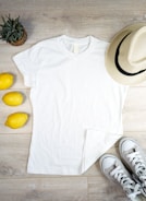 Flat lay of Lumina Apparel’s signature tees and accessories on a clean white background.