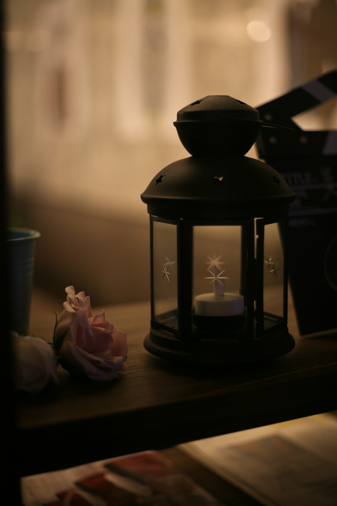 black candle lantern on brown wooden table